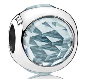 Silver charm with aqua blue crystal